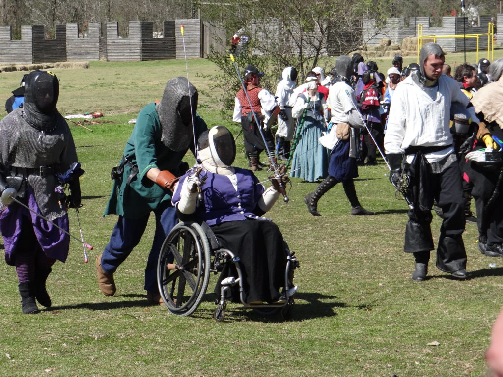A fencer in a wheelchair taking part in a battle