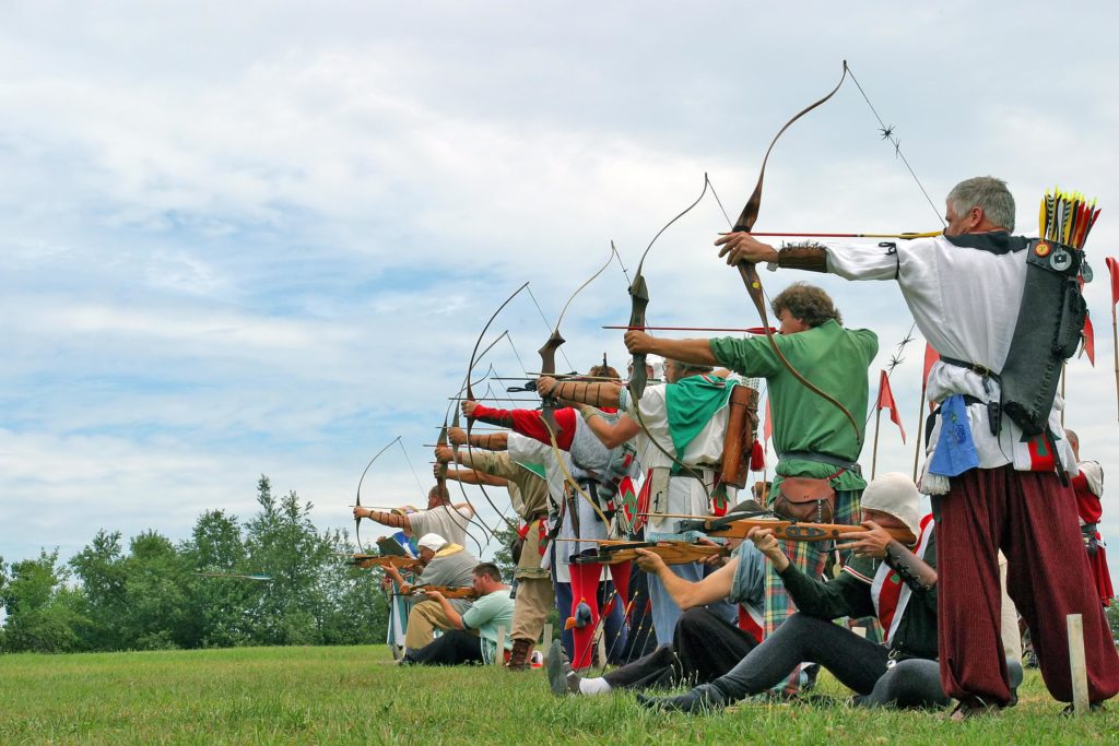 A row of archers aim at a target